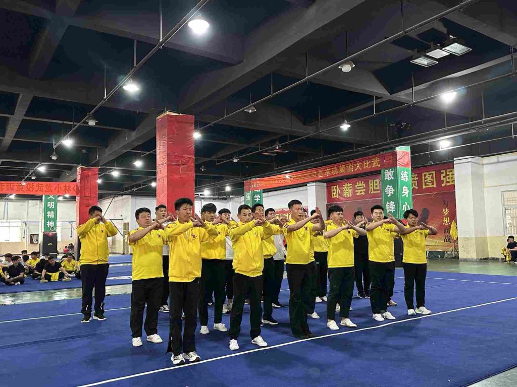 Dedicated practitioners perform a traditional respectful salute to begin their disciplined Shaolin daily routine.